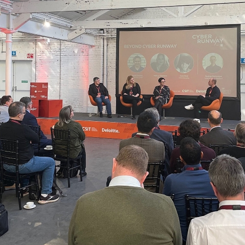 Conference audience and stage with panel of speakers